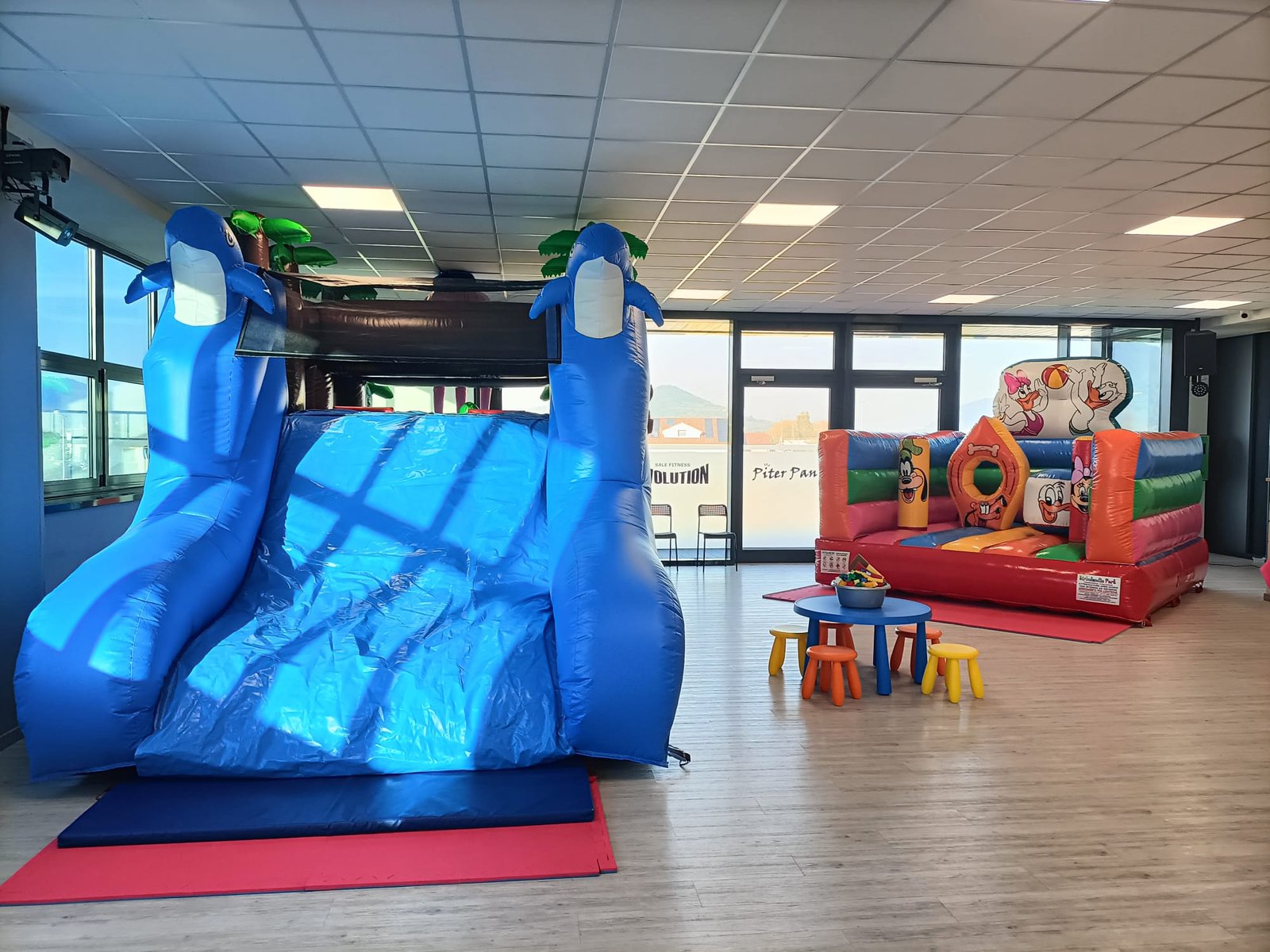 Gonfiabile a scivolo blu allestito all'interno della sala